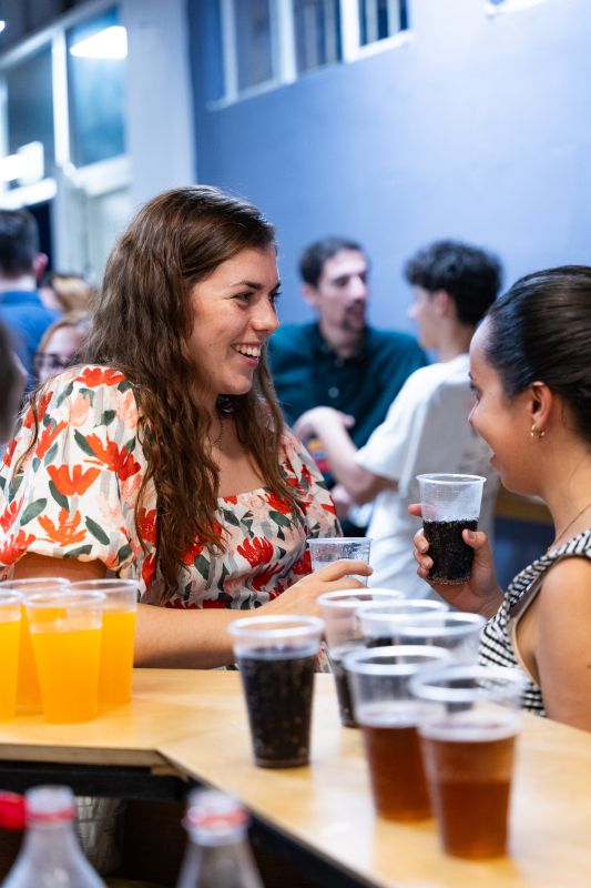 Friends talking and sharing drinks at SEVEN